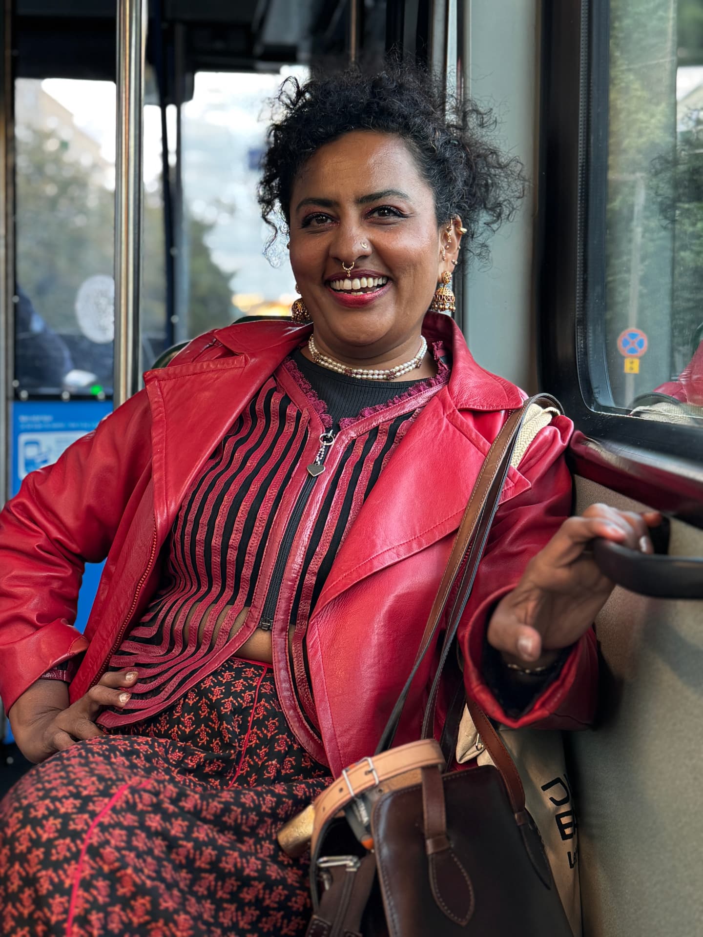 Vishnu Vardhani Rajan smiling in a red leather jacket